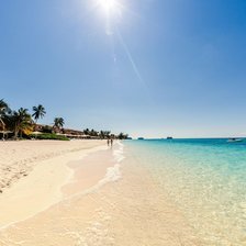Cayman Adventure Tours hotel pickup - quiet white sand stretch of Seven Mile Beach with calm turquoise water